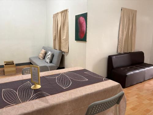 a room with two beds and a chair and a table at Mama's Tree Homey Studio in Ban Klaeng Lang