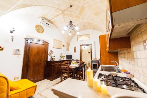 a kitchen with a table and a dining room at Antiche Corti in Scorrano