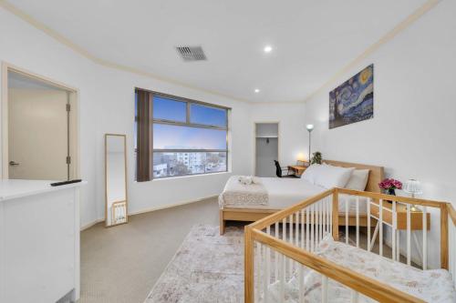 a bedroom with a bed and a window at Modern Metro by Host Solutions in Mawson Lakes