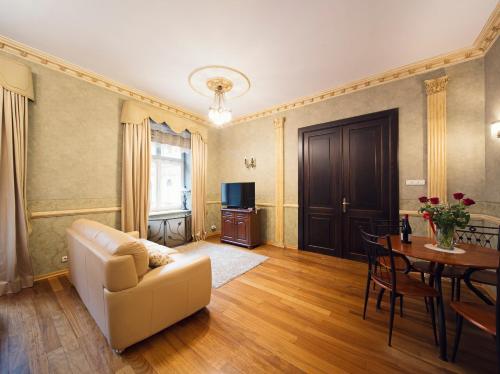 a living room with a couch and a table at Calliope Apartments in Krakow