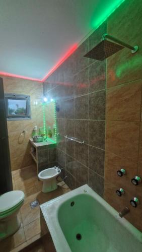 a bathroom with a tub and a toilet and a sink at Dpto 6 in La Cieneguita