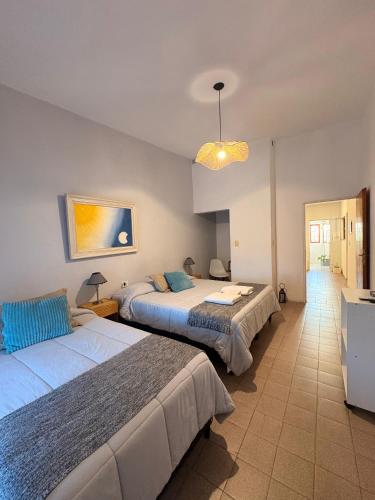 a bedroom with two beds and a light at Linas Apart & Suite in La Rioja