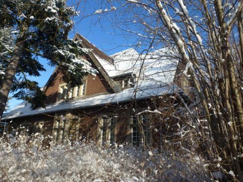 an old house with snow on the roof at Villa-Hufeland in Berlin