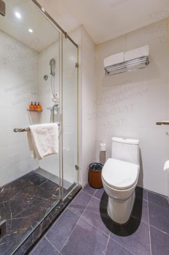a bathroom with a toilet and a shower at Orange Hotel Shanghai Wuzhong Road Metro Station in Shanghai