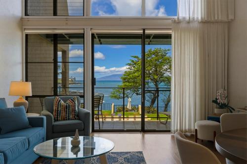 a living room with a view of the ocean at Prime Oceanfront 2BR Loft - Unit C10 condo in Lahaina