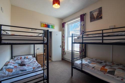 a bedroom with two bunk beds and a window at The Bunkroom in Chester