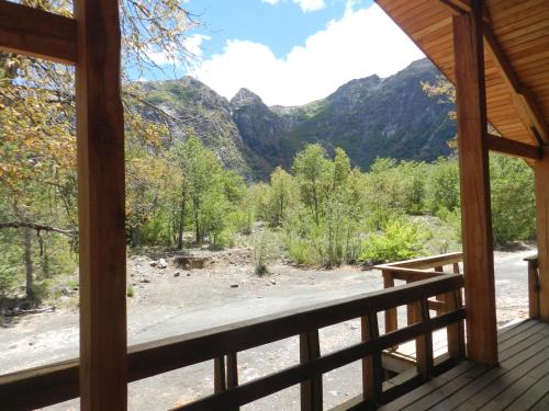 a view of the mountains from the porch of a cabin at Cabañas en Termas de Chillán in Recinto