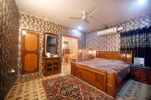 a bedroom with a bed and a bathroom at Pushkar Cooking Art and Home Stay in Pushkar
