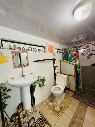 a bathroom with a toilet and a sink at Pension Mitiana in Tatoi