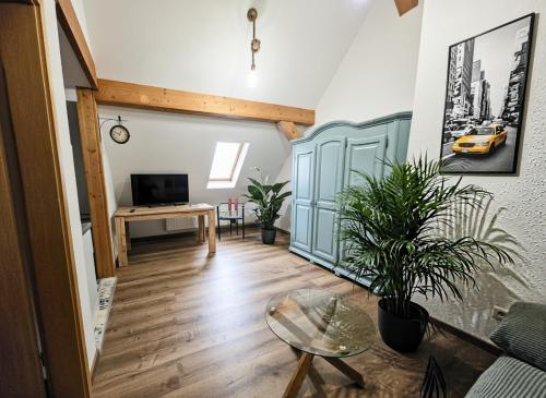a living room with a table and a tv at Ferienwohnung Feenblick in Kurort Altenberg
