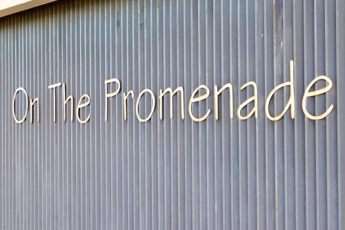 a sign that says on the promised on a metal wall at Sable Shores in Batemans Bay