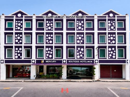 a large black and white building with a store at Mercury Boutique Hotel in Malacca