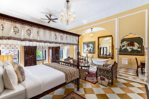 a bedroom with a bed and a tub in a room at Abheygarh in Khetri
