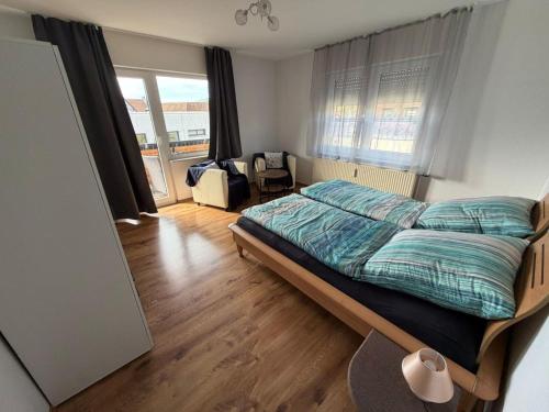 a bedroom with a bed and a chair in it at Ferienwohnung Alina in Hilders