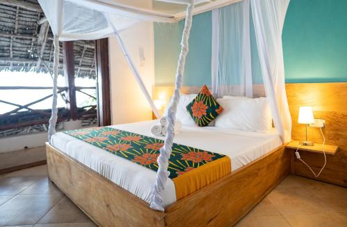 a bedroom with a swinging bed with a window at ZAN Jambiani Beach House in Jambiani