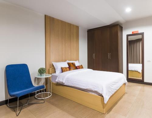 En eller flere senge i et værelse på BB Garden Resort