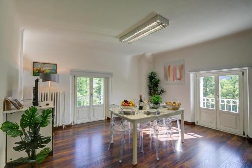 a dining room with a white table and chairs at Maroggia Apartments in Maroggia