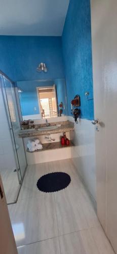 a bathroom with a sink and a mirror at Moraes Residence in Belo Horizonte