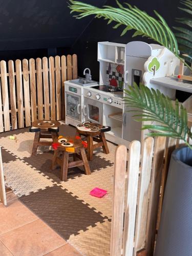 a toy kitchen with a stove and wooden tables at Guest House LeGourmet in Kata Beach