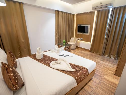 a hotel room with a bed and a television at GRAND ONE TOWER in Chennai