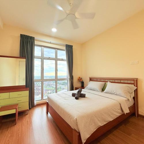 a bedroom with a bed with a teddy bear on it at KULAI IOI MALL D'Putra Suites Near JPO Senai Airport in Kampong Saleng