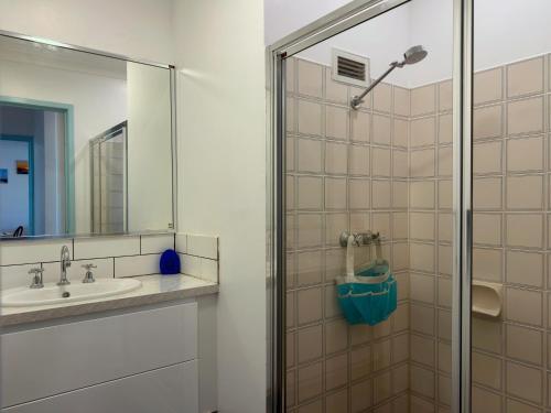 a bathroom with a shower and a sink at Sound Views Apartment in Safety Bay
