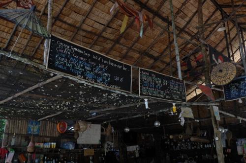 a sign hanging from the ceiling of a store at Mr. Chuoi Bar and Hut in Ko Phra Thong