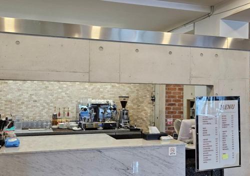 a kitchen with a counter with a machine on it at HwiMokArt Resort in Buan