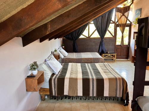 a bedroom with two beds in a attic at Cabañas M&S By GEstores in Huasca de Ocampo