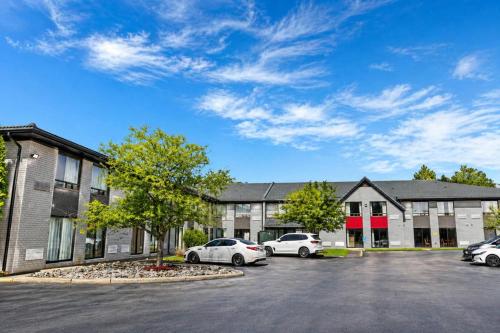 a parking lot in front of a building with cars at Comfort Inn in Huntsville