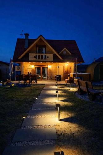 a building with a pathway in front of it at night at Leśne Zacisze Radawa I in Radawa