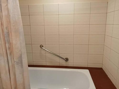 a bathroom with a tub and a shower curtain at Alta Vista Residences H102 in Boracay
