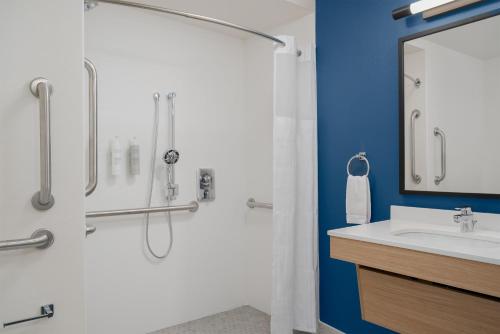 a bathroom with a shower and a sink at Spark By Hilton Seattle Airport in Seattle