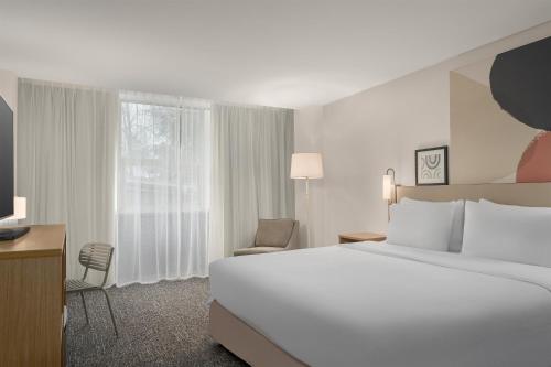 a hotel room with a large bed and a window at Spark By Hilton Seattle Airport in Seattle