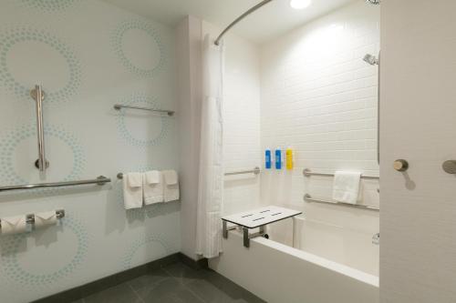 a white bathroom with a shower and a toilet at Tru By Hilton Hazleton in Hazleton