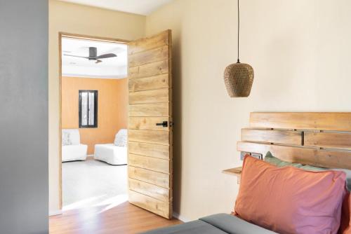 a door leading into a living room with a couch at Red Palm Villa in San Vicente