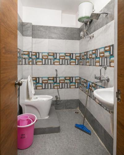 a bathroom with a toilet and a sink at Lighthouse Hostel in Udaipur