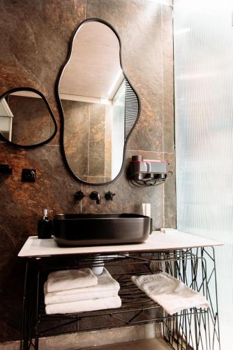 a bathroom with a sink and a mirror at Inn OZZ Almaty in Almaty
