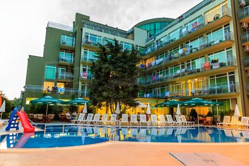 a large apartment building with a pool and a slide at Dalis Sunny Beach in Sunny Beach