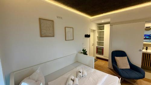 a bedroom with a bed and a blue chair at Design Apartment Arndt in Neustadt an der Weinstrasse in Neustadt an der Weinstraße