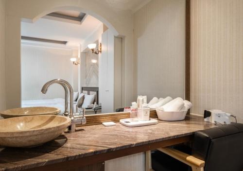 a bathroom with a sink and a large mirror at Ansan Seowon Tourist Hotel in Ansan