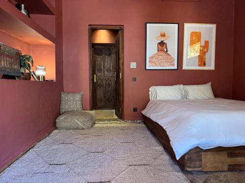 a bedroom with a large bed and a door at villa lalla Ourika & heated pool in Aghbalou