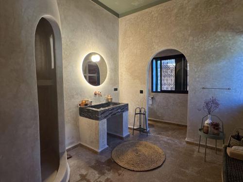 a large bathroom with a sink and a mirror at villa lalla Ourika & heated pool in Aghbalou