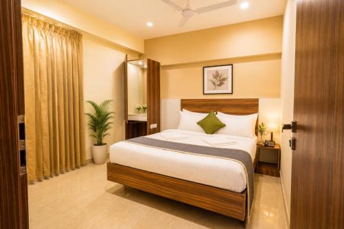 a bedroom with a large bed in a room at Urban Comforts - Near US Consulate Business Hotel in T Nagar in Chennai