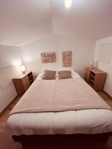 a bedroom with a large bed and two night stands at Loft Sous Pref in Montbéliard
