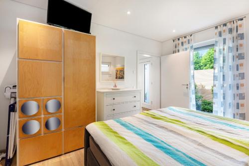 a bedroom with a bed and a tv on top at Ferienwohnung Am Hochrhein in Murg