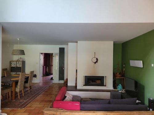 a living room with a couch and a fireplace at Peaceful Vosges heaven in Granges-Aumontzey