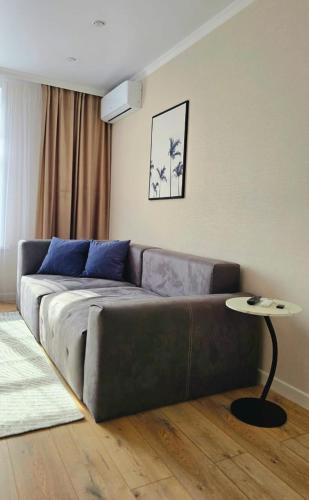 a living room with a couch and a table at Жк "AUEZOV" in Kokshetau