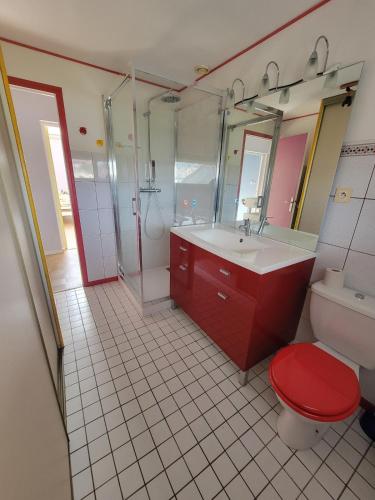 a bathroom with a red toilet and a sink at Peaceful Vosges heaven in Granges-Aumontzey