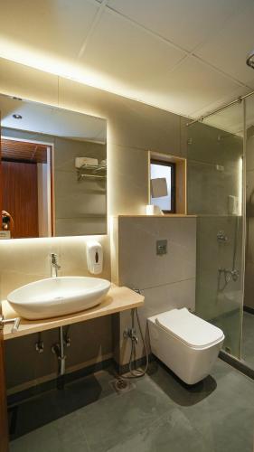 a bathroom with a sink and a toilet at Hotel Heritage Grand in Thane